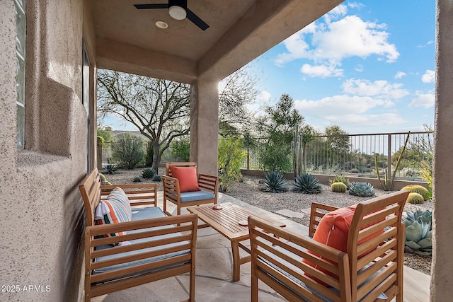 view of patio with an outdoor living space, fence, and a ceiling fan