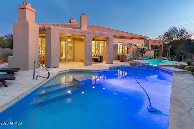 view of pool featuring a pool with connected hot tub and a patio