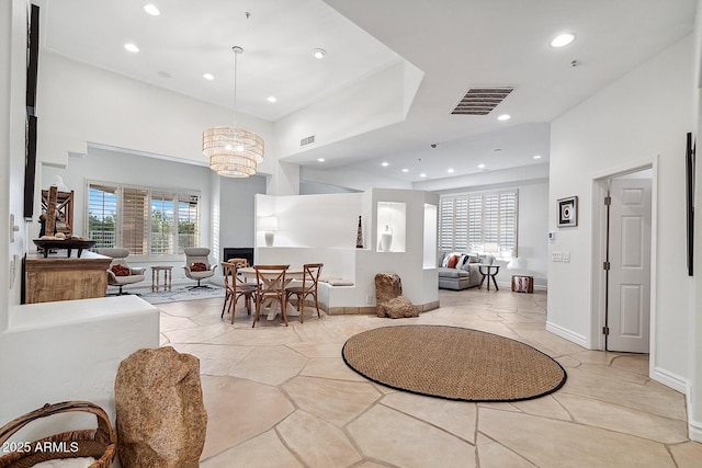 dining space featuring a chandelier, visible vents, and plenty of natural light