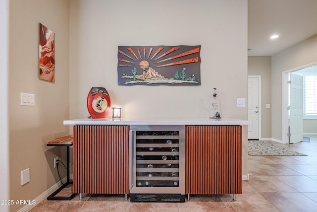 bar with wine cooler and light tile patterned floors