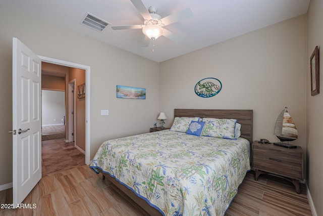 bedroom with hardwood / wood-style floors and ceiling fan