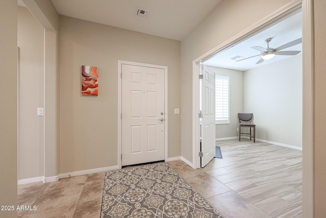 foyer entrance with ceiling fan