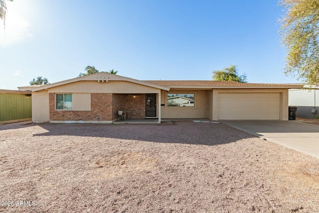 ranch-style house with an attached garage, driveway, and brick siding