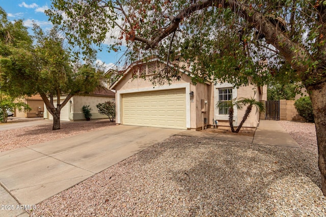 view of front of house with a garage, driveway, and stucco siding