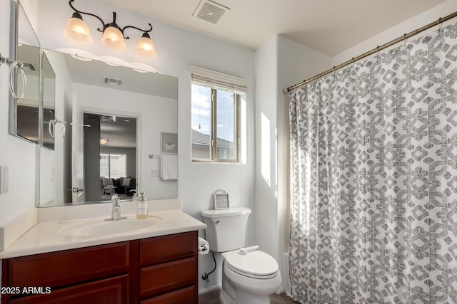 bathroom featuring walk in shower, vanity, and toilet