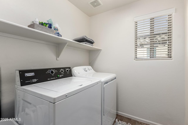 clothes washing area with washing machine and dryer