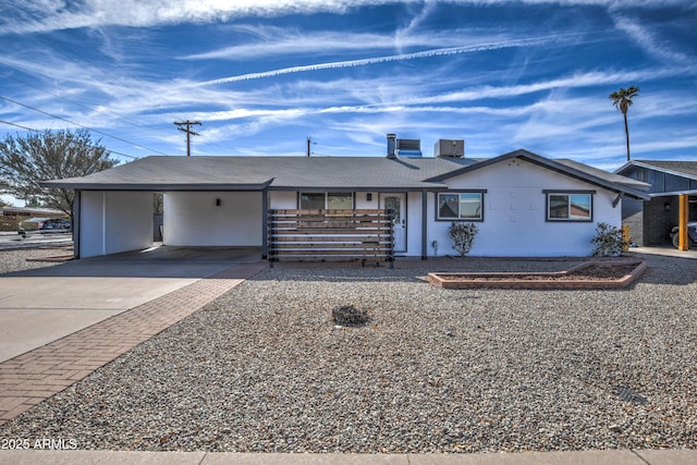 ranch-style home featuring a carport