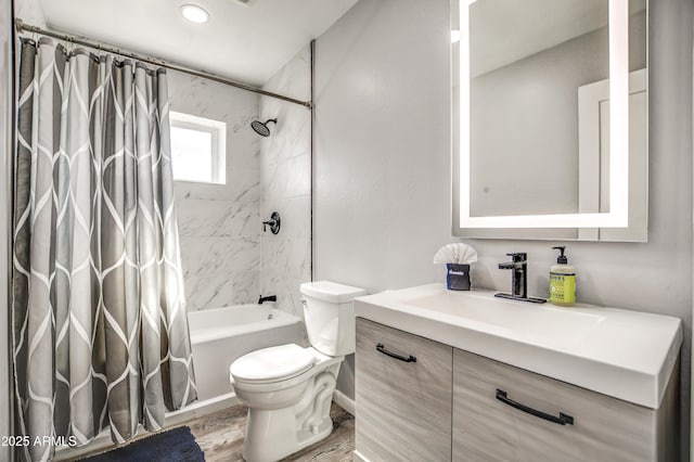 full bathroom with vanity, hardwood / wood-style floors, toilet, and shower / bath combo with shower curtain