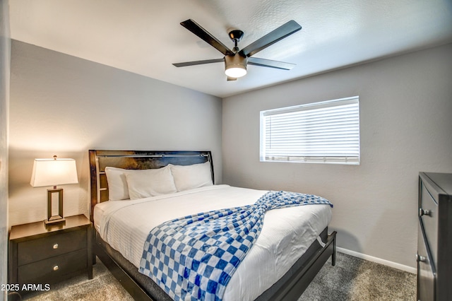 bedroom with dark colored carpet and ceiling fan