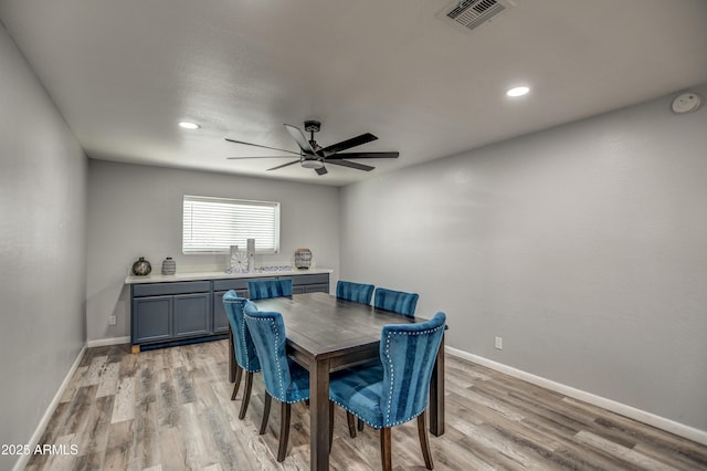 dining area featuring ceiling fan and light wood-type flooring