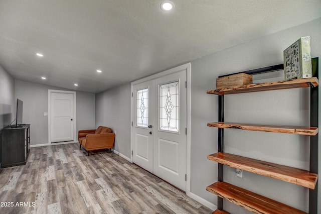 entrance foyer featuring light hardwood / wood-style floors and french doors