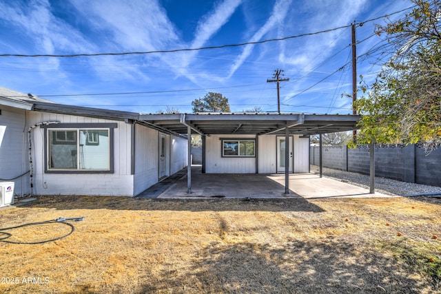 rear view of property featuring a carport