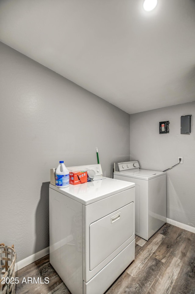 laundry area featuring washing machine and dryer and dark hardwood / wood-style flooring