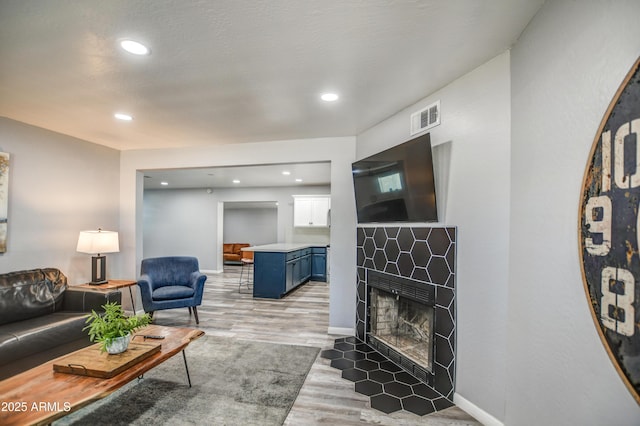 living room with light hardwood / wood-style flooring and a fireplace