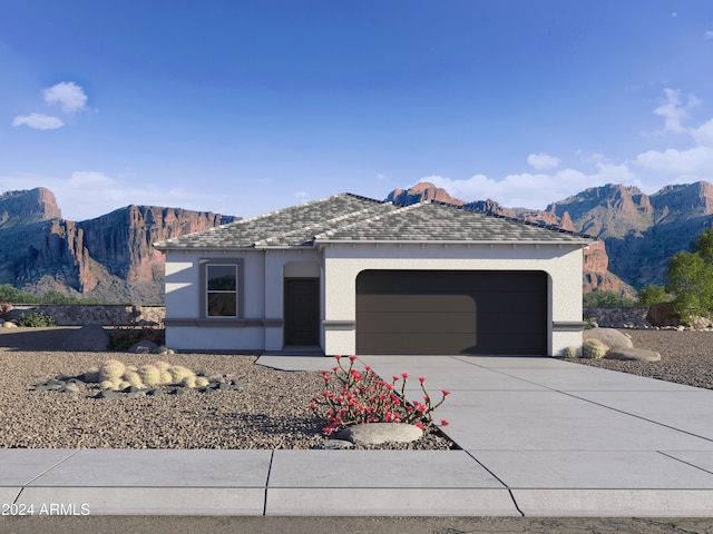 ranch-style house with an attached garage, a mountain view, concrete driveway, and stucco siding