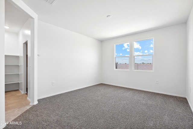 unfurnished room featuring carpet flooring