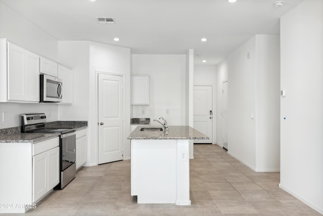 kitchen featuring sink, stainless steel appliances, an island with sink, and white cabinets