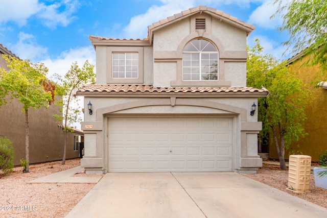 mediterranean / spanish-style home featuring a garage