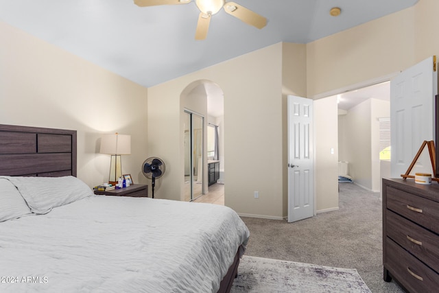 carpeted bedroom featuring ceiling fan and ensuite bathroom