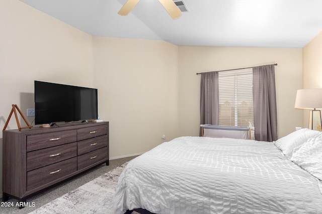 bedroom with ceiling fan, vaulted ceiling, and light colored carpet