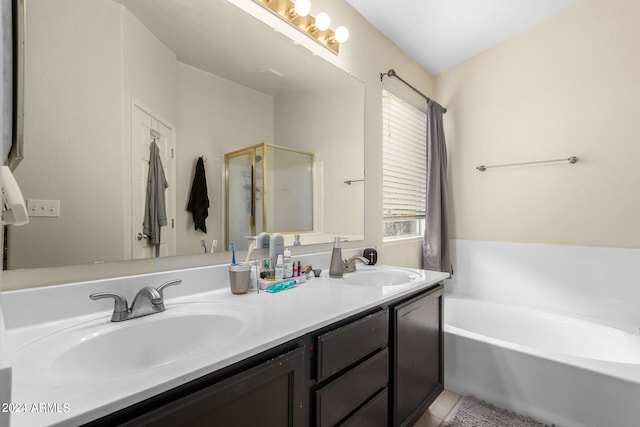 bathroom featuring vanity and independent shower and bath