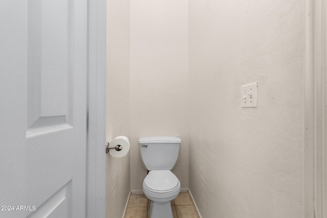 bathroom featuring tile patterned flooring and toilet