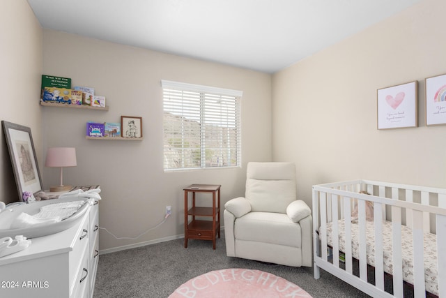 carpeted bedroom featuring a crib