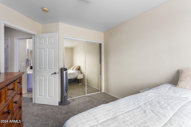 bedroom with dark colored carpet and a closet