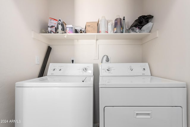 clothes washing area featuring washer and clothes dryer