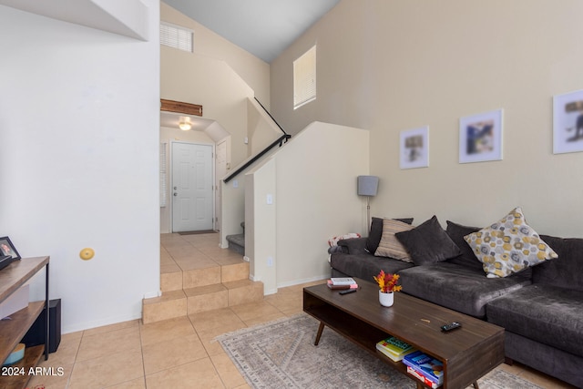 tiled living room with high vaulted ceiling