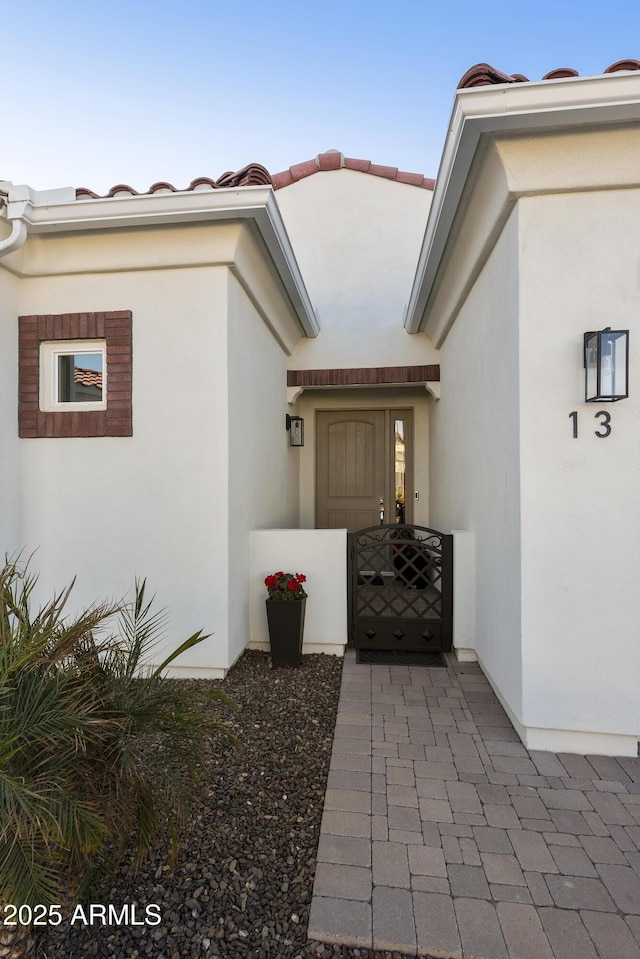 property entrance featuring stucco siding