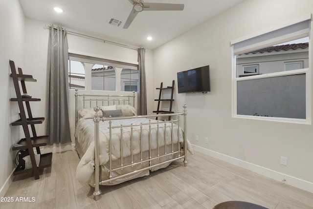 bedroom featuring light wood finished floors, recessed lighting, visible vents, and baseboards