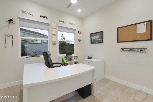 office space featuring light wood finished floors, baseboards, a ceiling fan, and recessed lighting