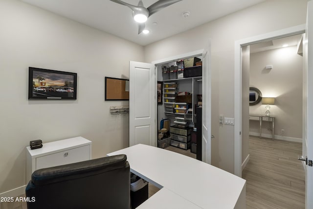 office featuring baseboards and light wood-style floors