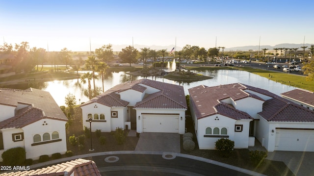 drone / aerial view with a water view and a residential view