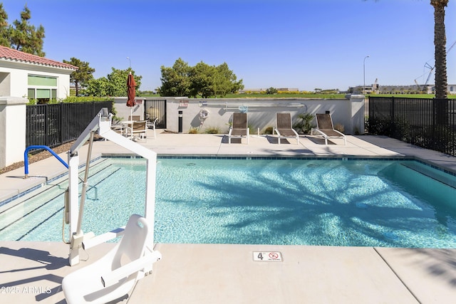 pool featuring a patio area and fence