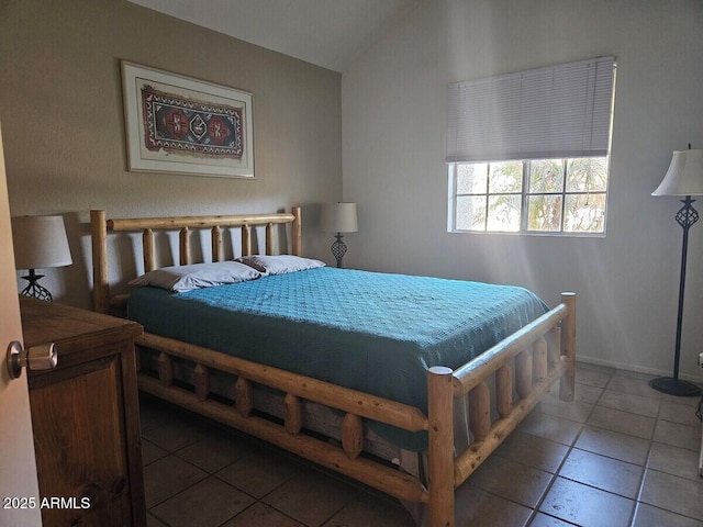 tiled bedroom featuring lofted ceiling
