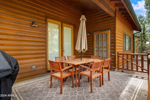 dining room with beamed ceiling and rustic walls