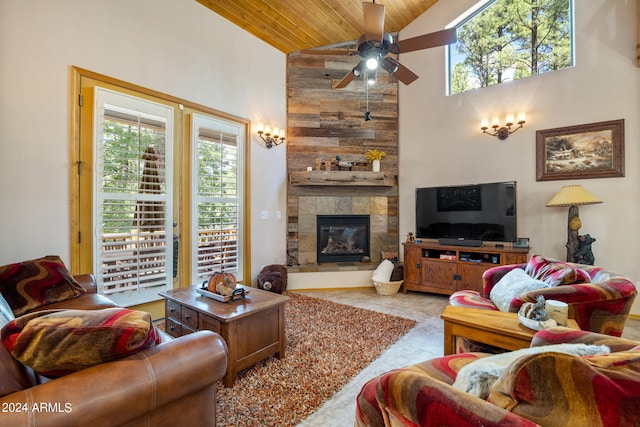 living room with ceiling fan, a tiled fireplace, high vaulted ceiling, and wooden ceiling