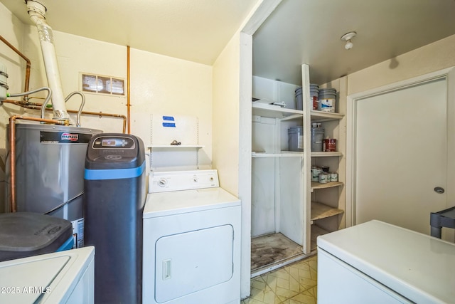 clothes washing area featuring water heater and separate washer and dryer