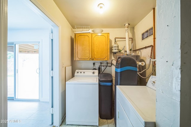 washroom featuring washer and dryer and cabinets