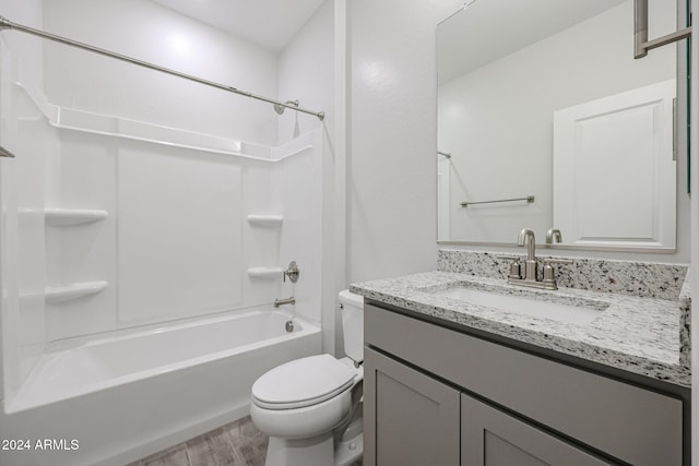 full bathroom with vanity, washtub / shower combination, wood-type flooring, and toilet