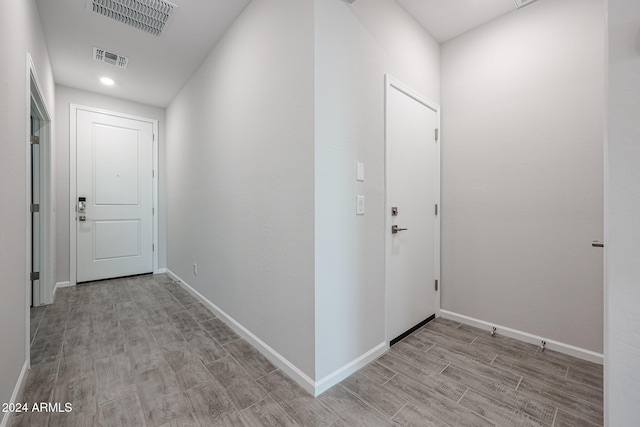 corridor with light hardwood / wood-style flooring