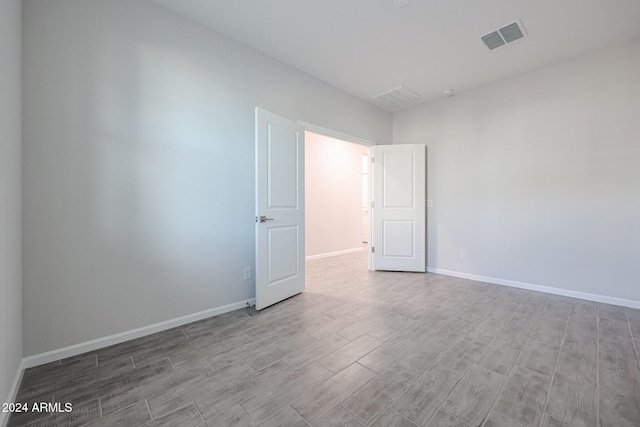 spare room featuring light hardwood / wood-style floors