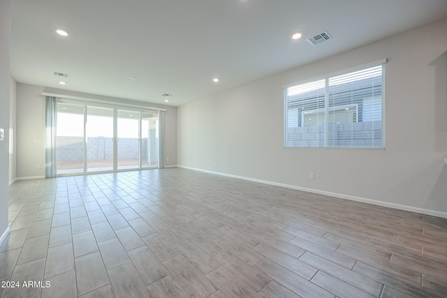 empty room with light hardwood / wood-style flooring