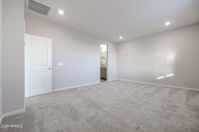 spare room with light carpet