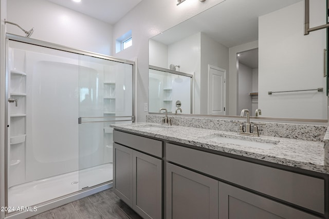 bathroom featuring vanity, wood-type flooring, and an enclosed shower