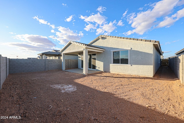 rear view of property featuring a patio area