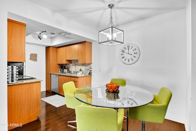7350 N Via Paseo Del Sur Unit O202, Scottsdale, AZ 85258 - dining area with visible vents, a raised ceiling, baseboards, dark wood-style floors, and a chandelier