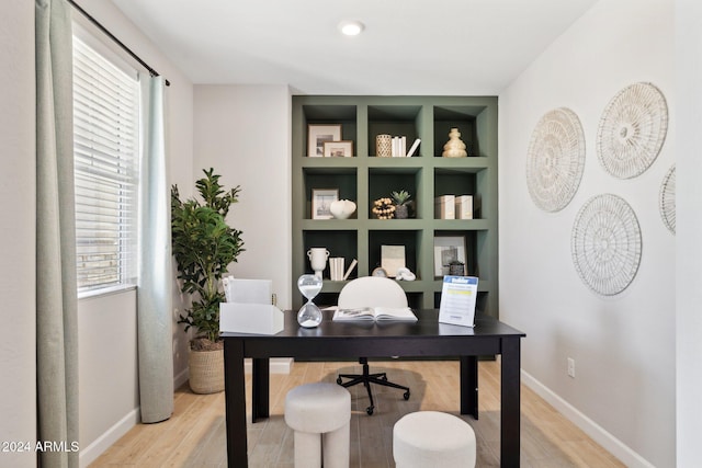 home office featuring a healthy amount of sunlight and wood-type flooring